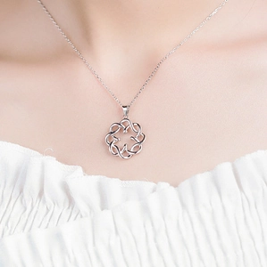 Close-up of S925 sterling silver hollow floral pendant on a delicate cable chain