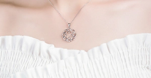 Close-up of S925 sterling silver bow knot pendant necklace on a female model collarbone