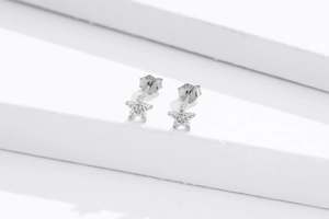 Detail shot of S925 sterling silver star stud earrings with sparkling cubic zirconia pavé