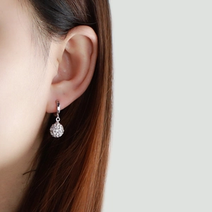 Close-up of S925 sterling silver geometric drop earrings with sparkling crystal pave ball