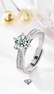 Detailed macro of a six-prong silver ring featuring a round brilliant-cut solitaire stone