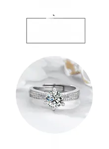 Macro shot of six-prong solitaire ring with double row side stones on silver band
