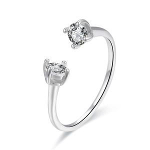 Macro shot of silver open ring with dual round-cut cubic zirconia and polished finish