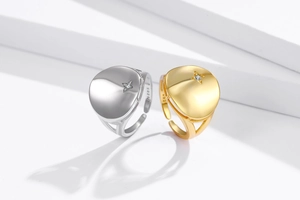 Detail of silver and gold adjustable rings showing S925 hallmark and star-set diamond