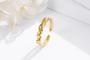 Detailed view of gold twisted S925 sterling silver adjustable knot ring with mirror finish
