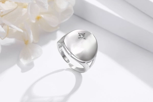 Macro detail of S925 sterling silver ring with star-set zircon and open adjustable band