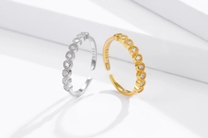 Detail view of gold and silver S925 rings featuring rows of clear cubic zirconia