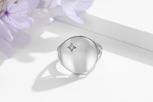Macro shot of polished S925 sterling silver signet ring with star set cubic zirconia