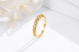 Macro shot of S925 sterling silver gold ring with inlaid cubic zirconia and bead detailing