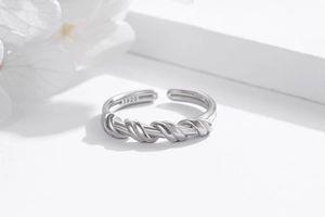 Detailed close-up of S925 sterling silver hallmark on adjustable twisted knot ring