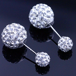 Macro detail of 925 silver double-sided stud earrings with shimmering disco balls