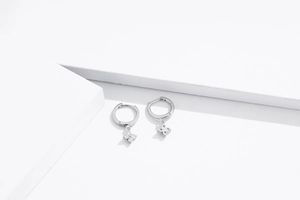 Detail of S925 sterling silver hoop earrings with four-leaf clover zircon charms