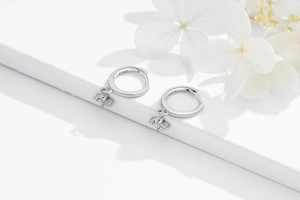 Close-up of S925 sterling silver earrings with four zircon stones in a floral design