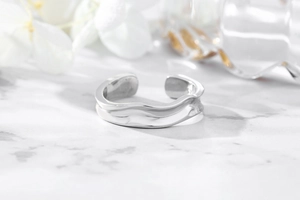 Detailed macro shot of irregular wavy S925 sterling silver adjustable open ring
