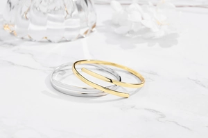 Detail showing S925 hallmark on minimalist polished gold and silver open cuff bracelets