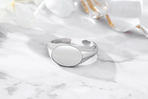 Macro detail of minimalist S925 sterling silver ring with smooth oval signet surface