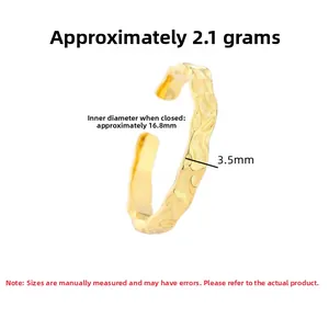 Close-up of golden irregular hammered ring texture with 3.5mm width and 2.1g weight