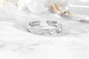 Macro detail of irregular hammered texture on S925 sterling silver adjustable open ring