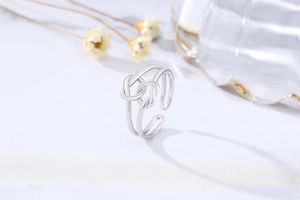 Close-up of S925 sterling silver double-layered bow ring with polished minimalist finish