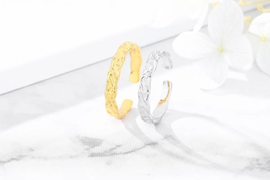 Detail of S925 sterling silver open rings with irregular hammered texture in gold and silver