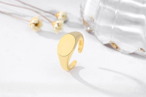 Detail of S925 sterling silver signet ring with polished gold finish and oval surface