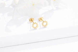 Close-up of S925 sterling silver sun earrings with gold finish and hallmark stamp