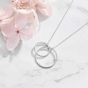 Elegant S925 sterling silver interlocking double circle pendant necklace on marble surface
