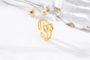 Detail of adjustable golden double-layered bow knot ring with high-polished finish