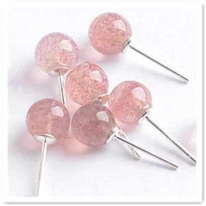 Close-up of translucent red strawberry quartz beads on silver stud earring posts