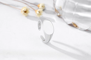 Macro detail of S925 sterling silver minimalist ring showing the polished oval signet surface