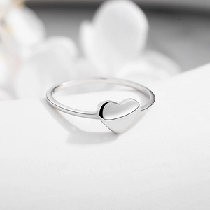 Minimalist S925 sterling silver heart ring with polished mirror finish on stone texture