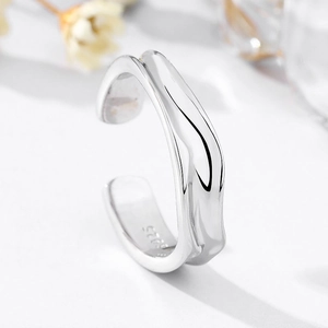 Macro shot showing the S925 hallmark on minimalist irregular wavy silver ring