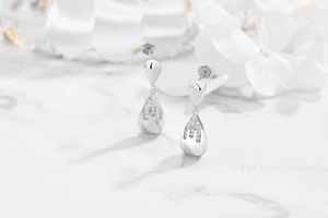 Macro detail of S925 sterling silver teardrop earrings featuring pavé cubic zirconia