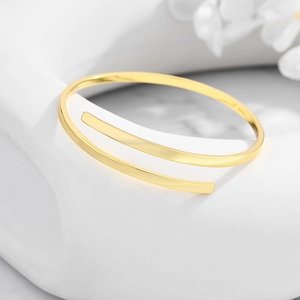 Close-up of S925 sterling silver minimalist cuff bracelet with polished golden finish