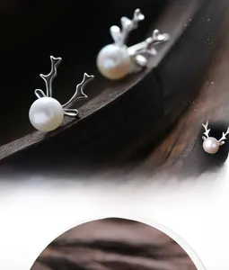 Macro side view of S925 silver reindeer antler earrings with a white freshwater pearl