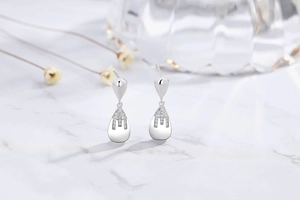 Detail of 925 sterling silver drop earrings featuring micro-set sparkling cubic zirconia