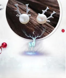 Detail of S925 silver reindeer antler earrings with pearls in festive holiday display