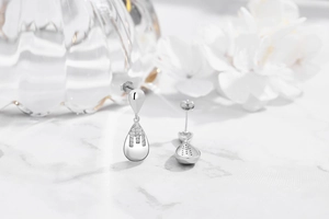 Macro detail of S925 sterling silver long teardrop earrings with micro-inlaid zircon pavé
