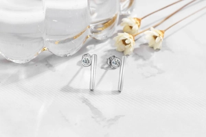 Macro detail of minimalist S925 sterling silver stud earrings with round cubic zirconia