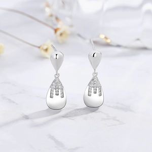 925 silver long teardrop earrings with micro-set diamonds on white marble