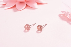 Detailed view of S925 silver stud earrings with natural pink strawberry quartz beads