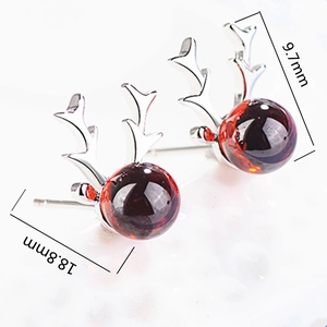 Macro detail of silver reindeer antler studs with 9.7mm red beads and 18.8mm dimensions