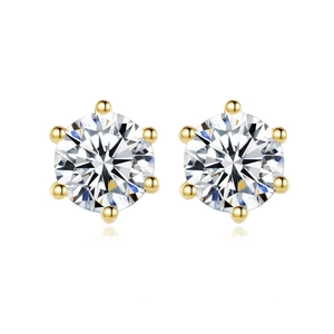 Close-up of classic six-prong gold-plated stud earrings with sparkling white zircons