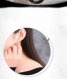 Close-up of S925 sterling silver reindeer antler earrings with white pearls on a model