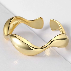 Vista macro de anillo dorado ondulado con acabado de espejo pulido y diseño escultórico