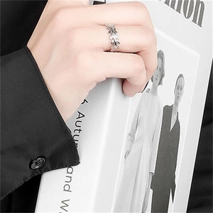 Detailed view of sterling silver leaf ring with olive branch design on a model's finger