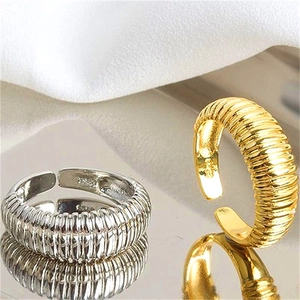 Detail of 925 silver croissant rings with textured gold and silver finish on mirror