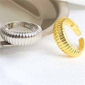 Macro detail of S925 sterling silver stamp on minimalist croissant ripple rings