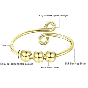 Detail of 925 sterling silver ring featuring three rotating gold beads and adjustable band
