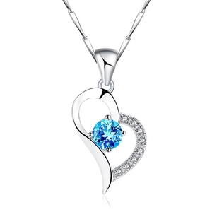 Close-up of S925 silver heart necklace with a blue gemstone and small cubic zirconia